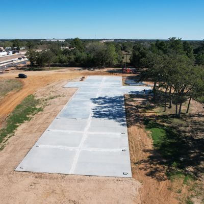 aerial view 2 of concrete slab foundation for 50x235 metal building near Columbus Texas
